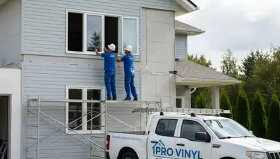 Technician repairing residential window with vinyl siding in Rochester, NY